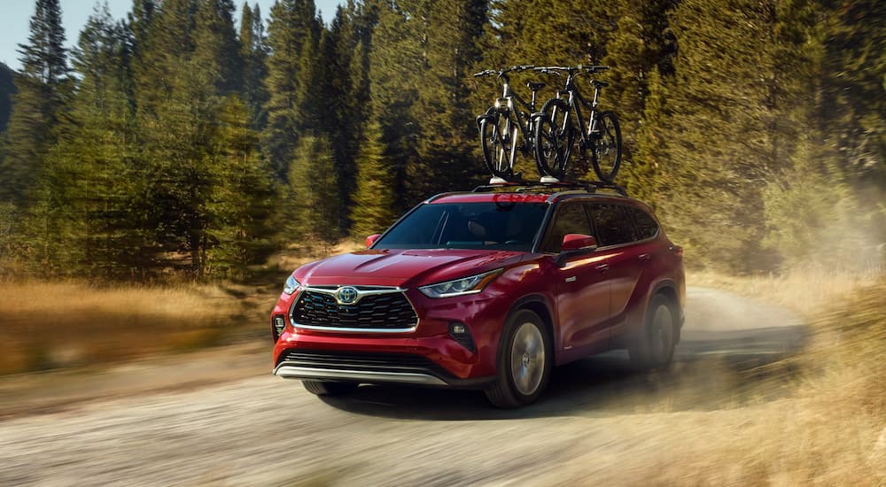 A red 2020 Toyota Highlander is shown from the front at an angle.