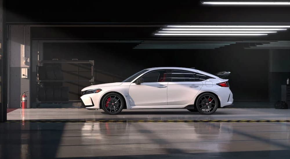 A white 2023 Honda Civic Type R is shown parked in a garage.