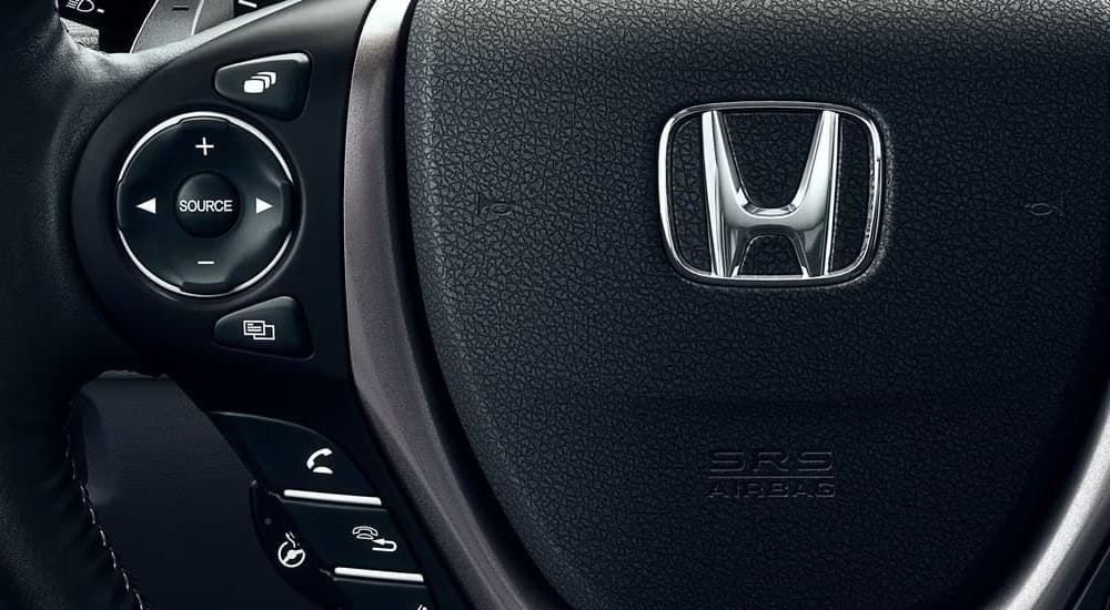 The steering wheel is shown in a 2023 Honda Ridgeline for sale.