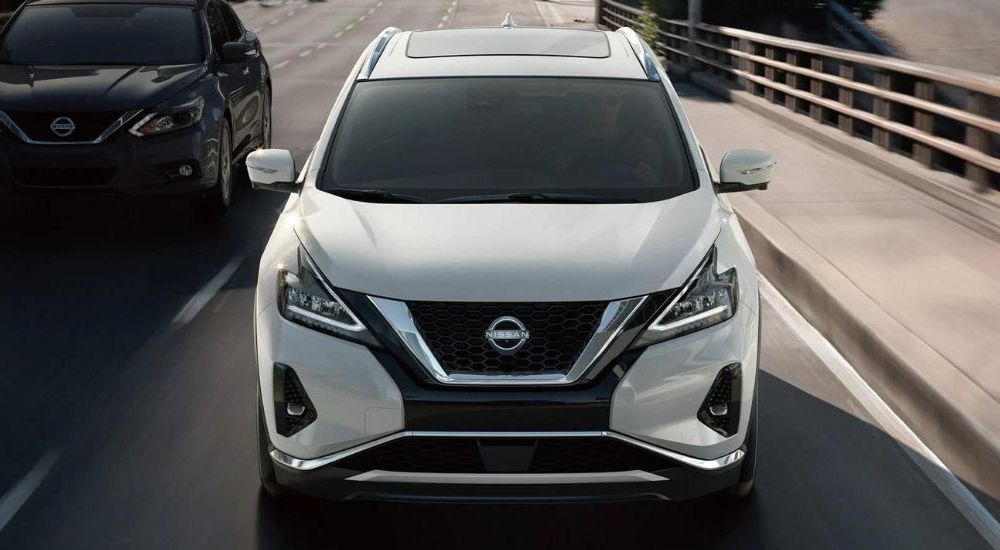 A white 2021 Nissan Murano is shown driving in traffic.
