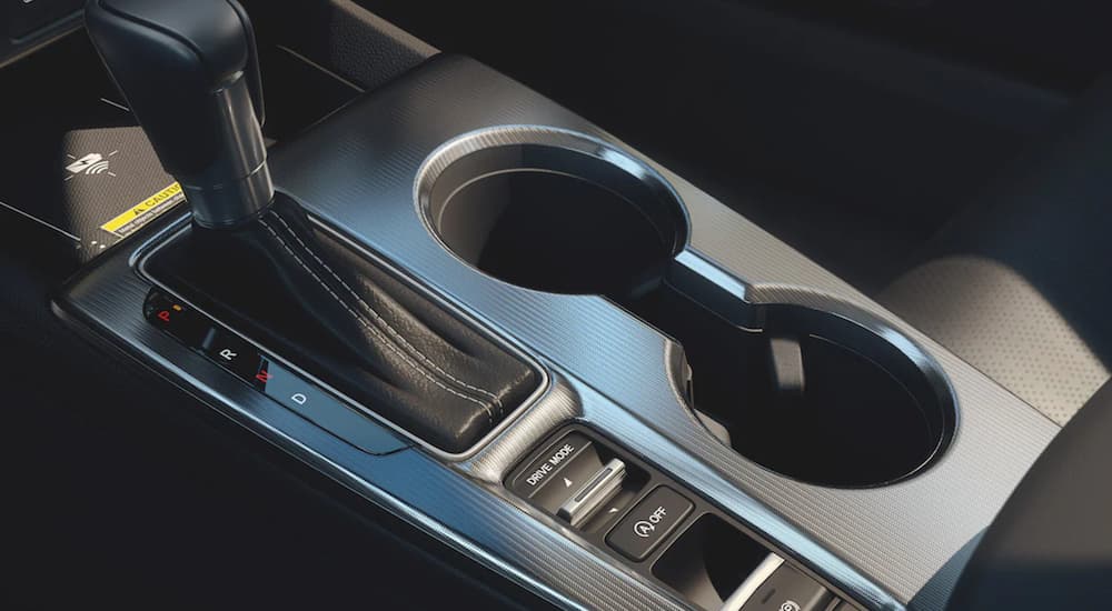 The silver cupholders in the interior of a 2022 Honda Civic Touring are shown.