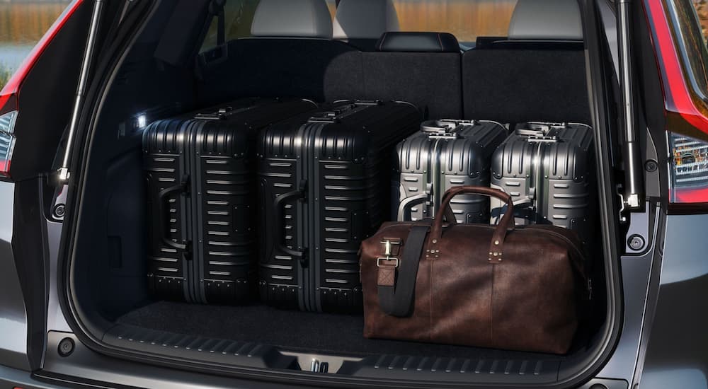 Suitcases lined up in the trunk of a 2024 Honda CR-V Sport Touring, one of many used SUVs for sale near Odessa.